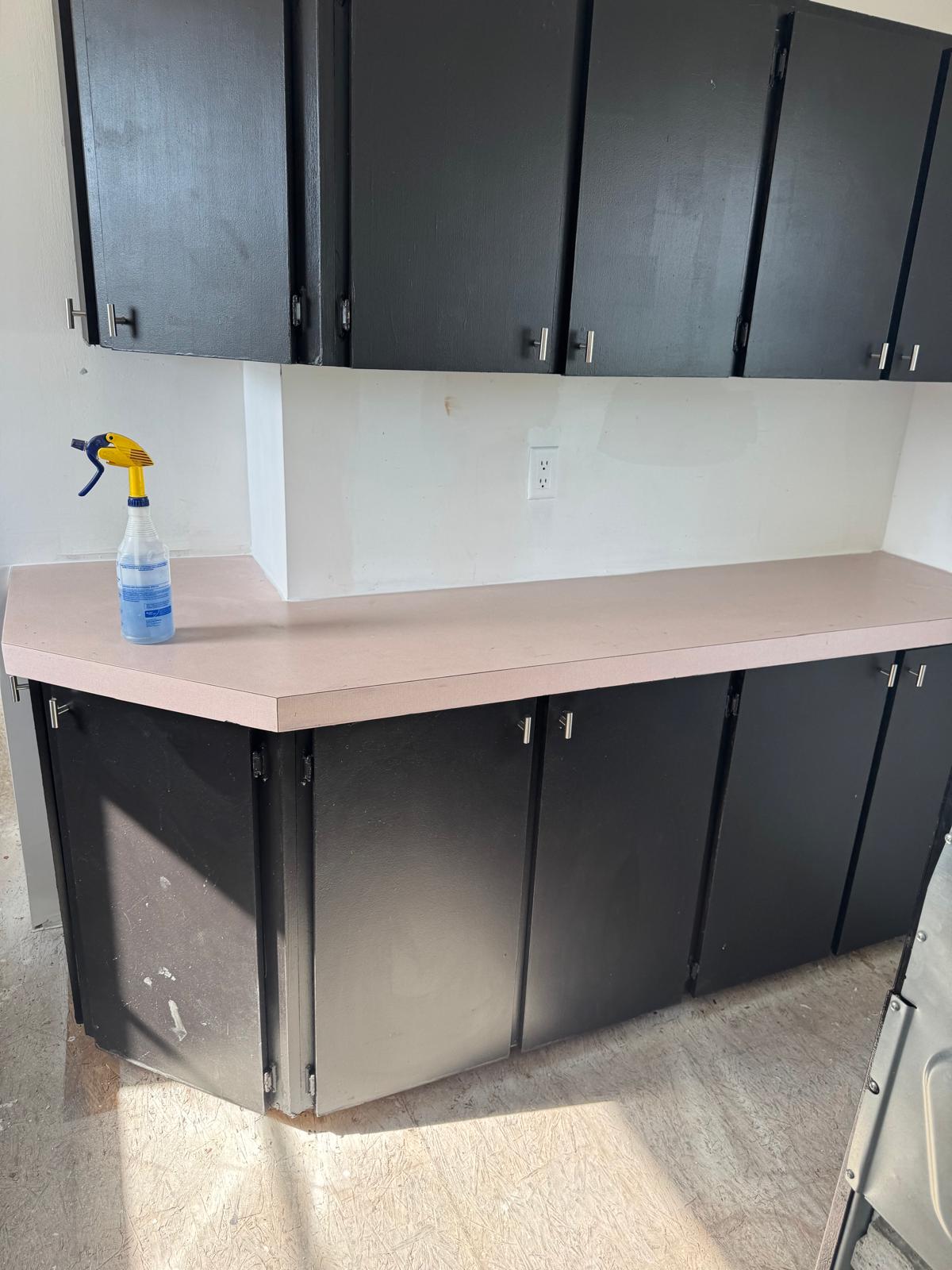 Kitchen cabinets refinished in matte black with brushed nickel bar pulls