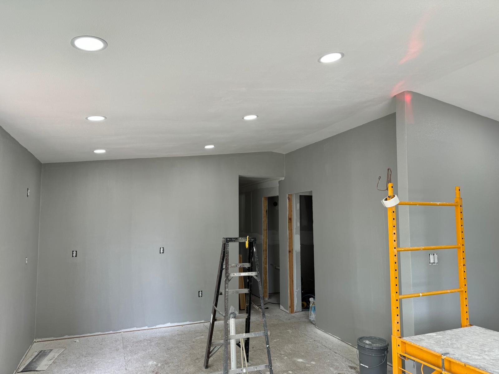 Freshly finished and painted drywall room with new recessed can lighting