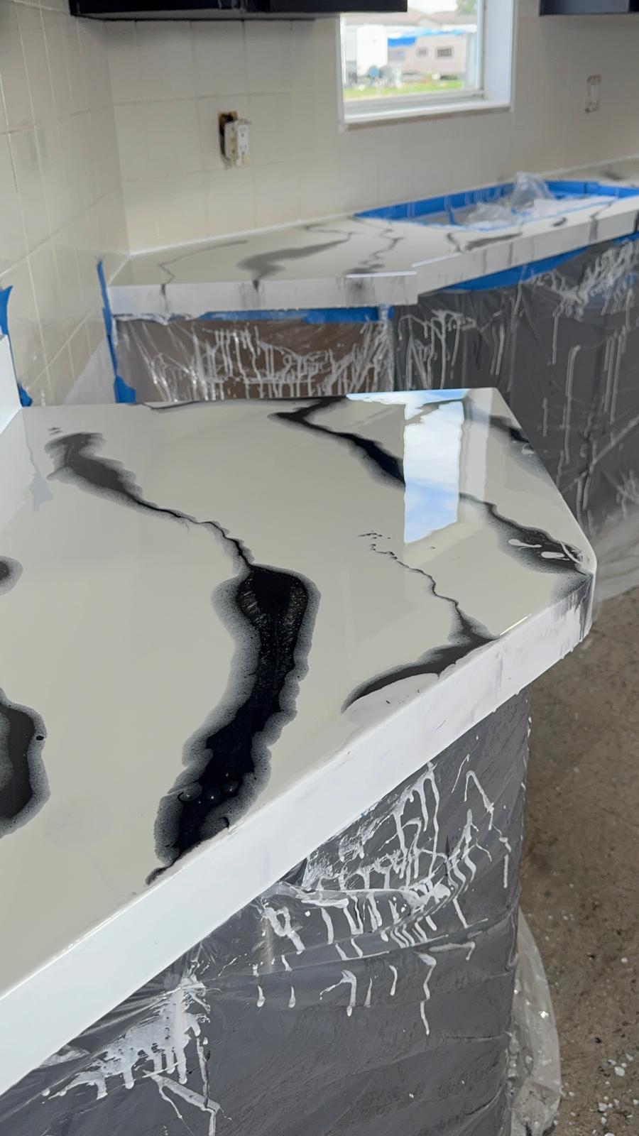Glossy white and black marble-look epoxy countertop poured over an existing kitchen counter
